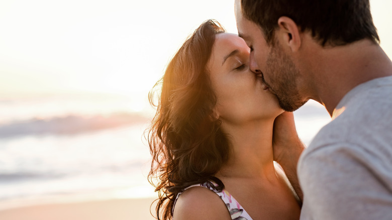 Couple kissing by the beach