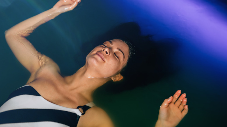 Woman floating in float tank