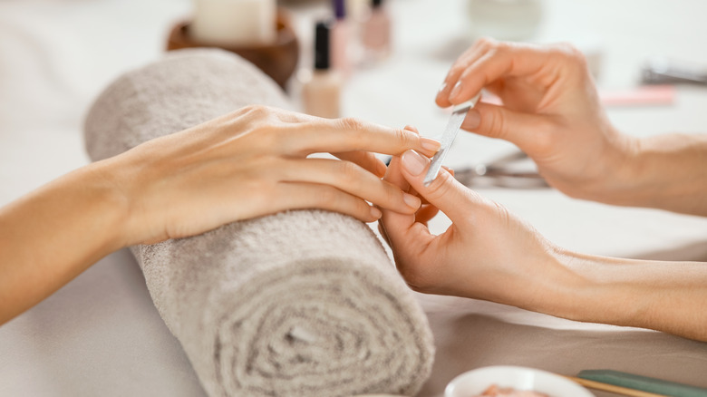 Person getting nails at salon