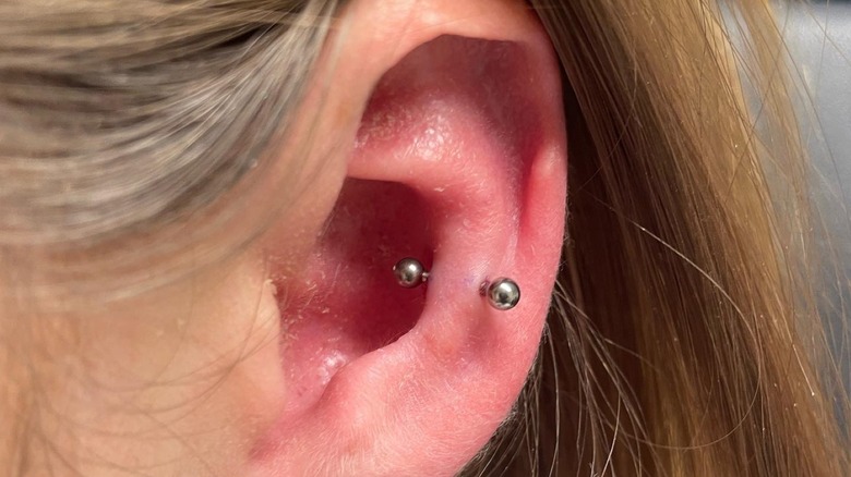snug piercing in an ear