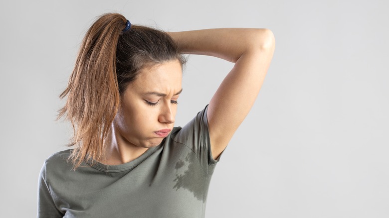 Woman with underarm sweat stain