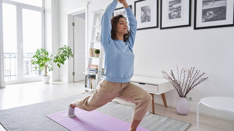 Woman in low lunge at home