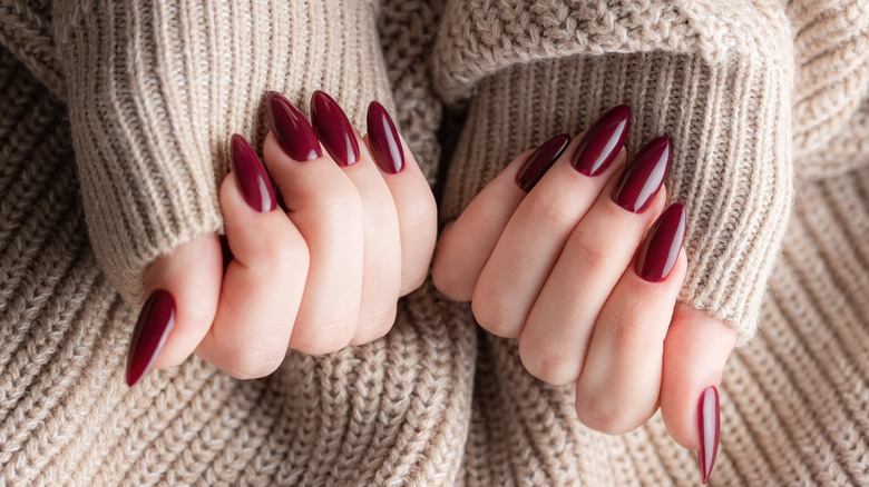 woman with long crimson nails