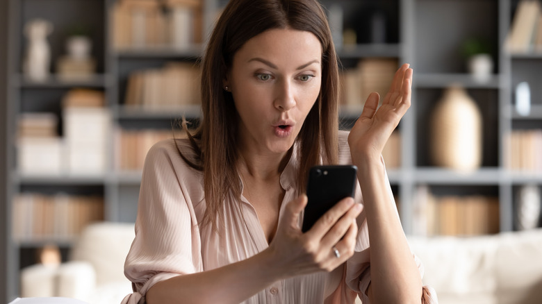 surprised woman looking at phone