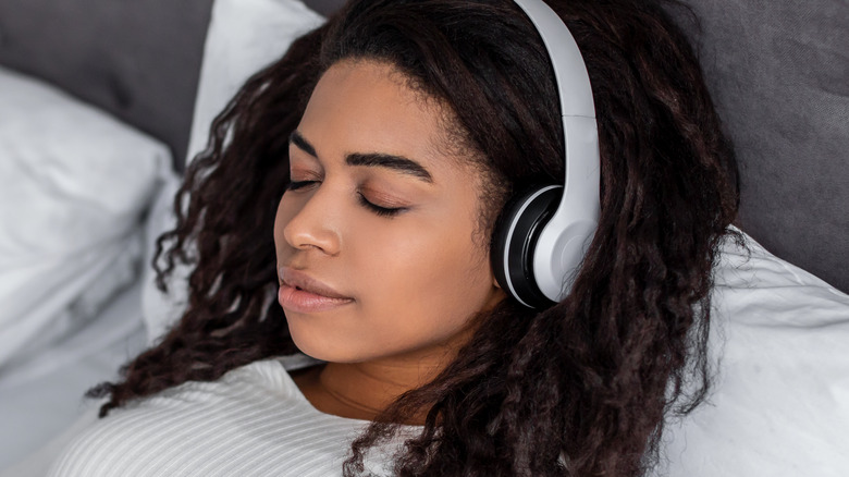 Black woman sleeping with headphones