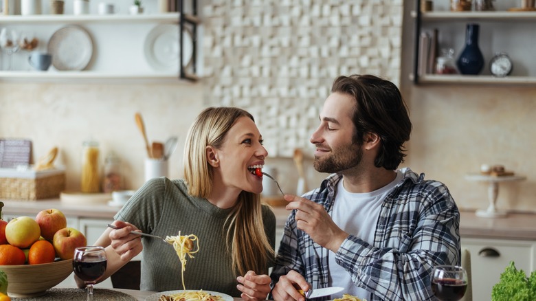 Couple eating together in kitchen