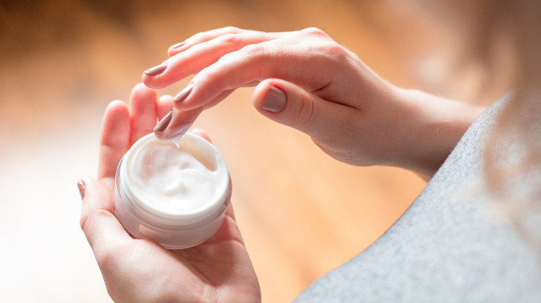 woman using moisturizer