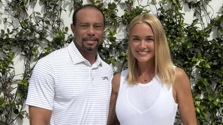 Tiger Woods stands arm in arm with Vanessa Trump