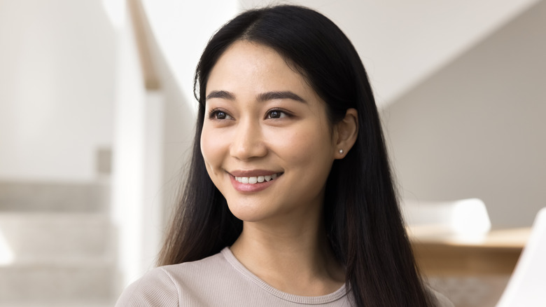 Woman with straight black hair smiling
