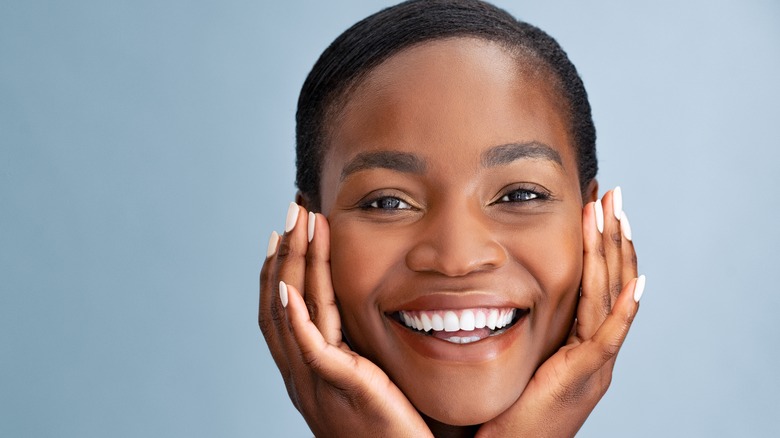 woman massaging her face