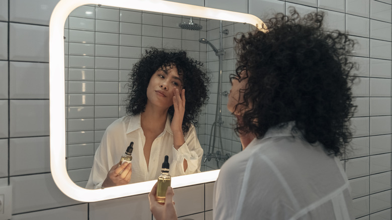 Woman applying face oil