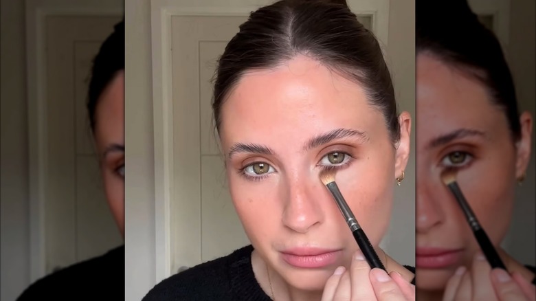 Woman applying brown eyeshadow