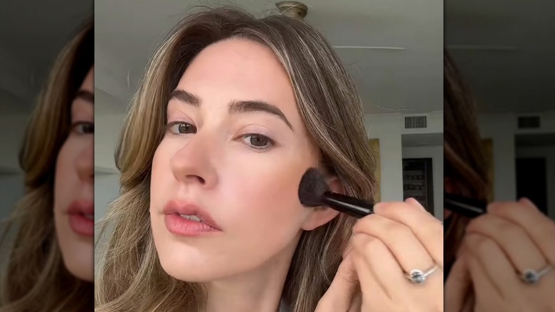 A woman applying contour