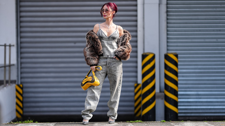 Heart Evangelista at Milan Fashion Week in acid wash jeans in 2026.