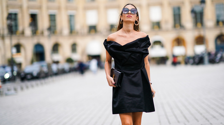 Woman wearing black off-the-shoulder dress