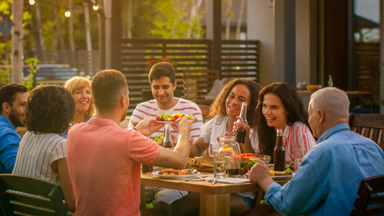 family sharing meal outdoors