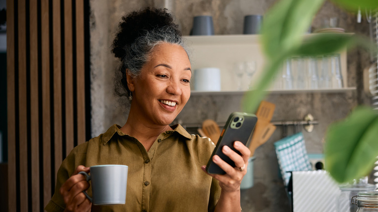 Woman looking at phone smiling