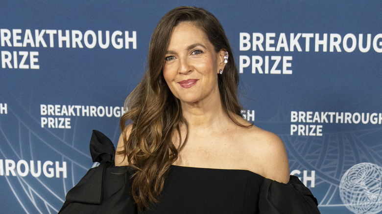 Drew Barrymore gives a soft smile to the camera during a red carpet photo-op