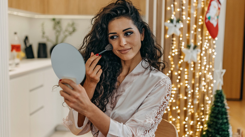 A woman applying her makeup