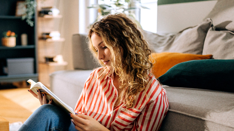 Woman reading a book at home