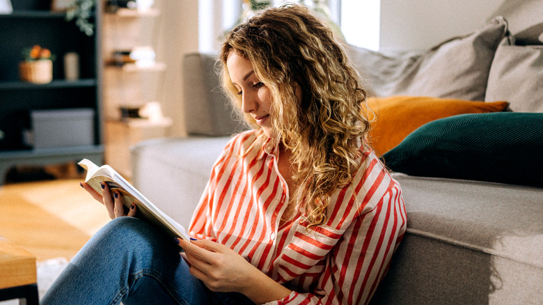 Woman reading a book at home