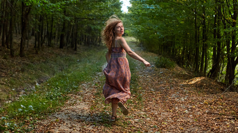 woman running through the forest