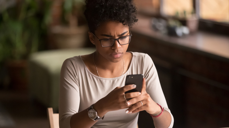 woman looking at her phone