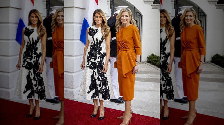Melania Trump posing with Queen Máxima in a black and white floral dress