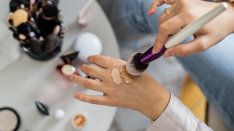 woman blending concealer