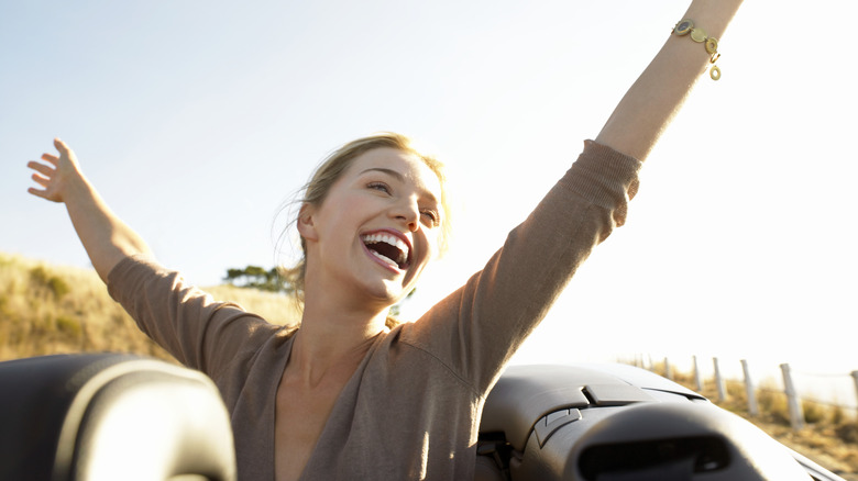 Woman in convertible smiling 
