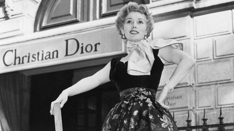 A model in Paris in the 1950s standing outside Christian Dior
