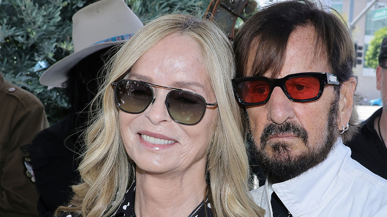 Barbara Bach wearing sunglasses pictured with Ringo Starr