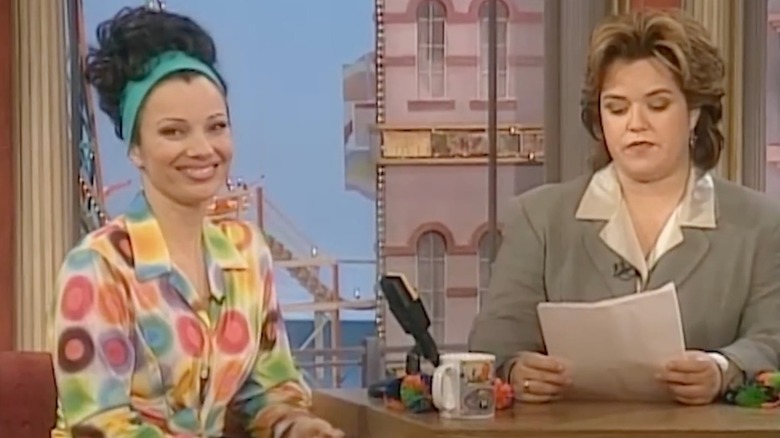Fran Dresher wears a long orange and black maxi dress in 1994