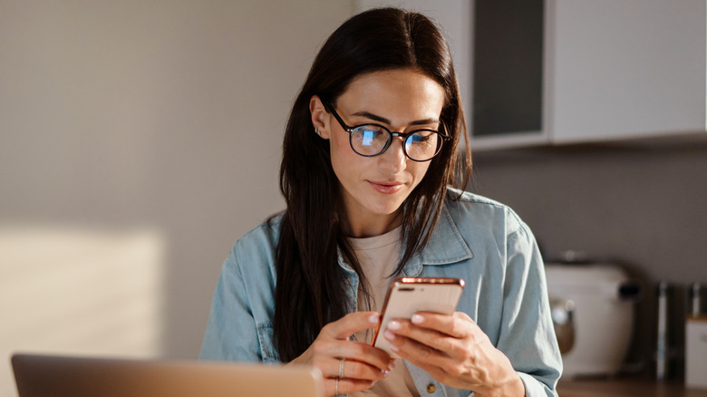 woman looking at her phone