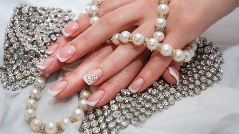 French manicure with pearl jewelry