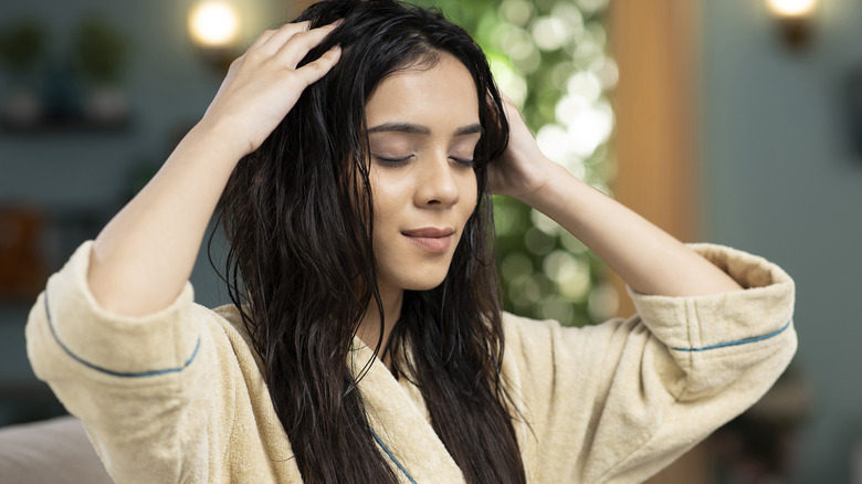 Woman running product through hair