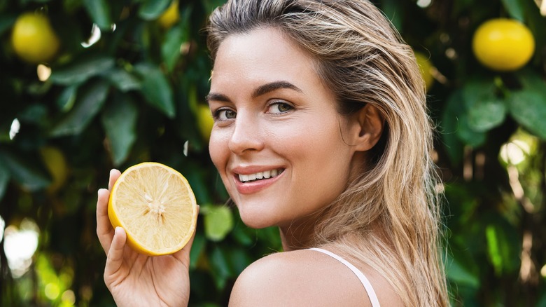 Woman surrounded by lemons