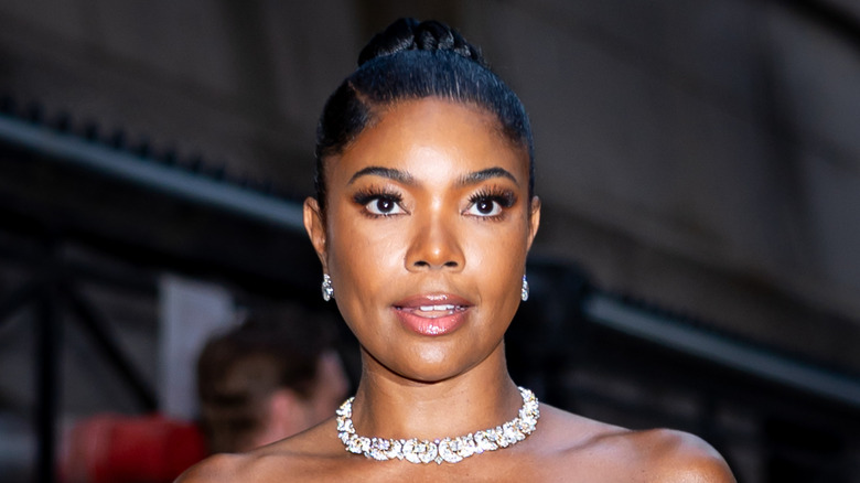 Actor Gabrielle Union wears a slicked back bun and diamond necklace