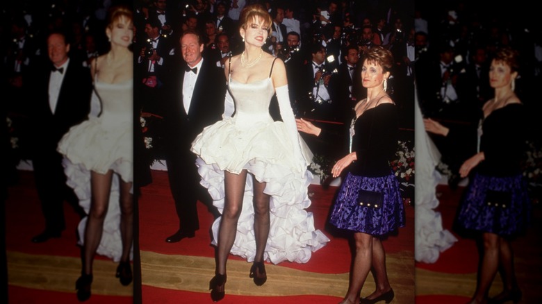 Geena Davis walks up the red carpet, wearing a white ruffled gown, at the Academy Awards, Los Angeles, California, on March 30, 1992