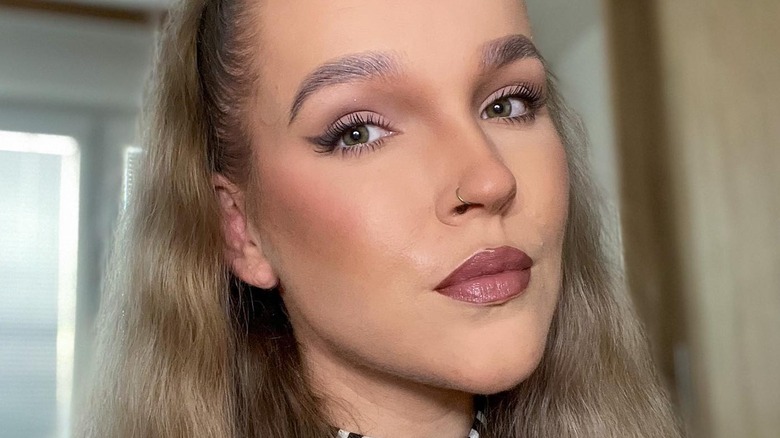 Woman trying passport makeup trend