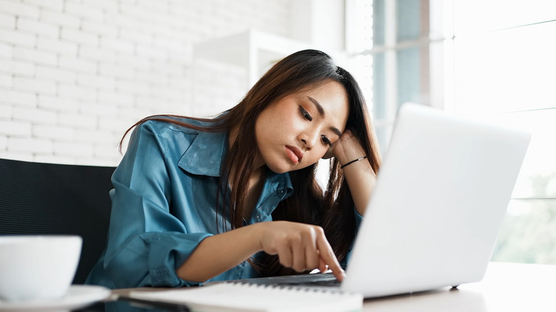 Bored woman with laptop