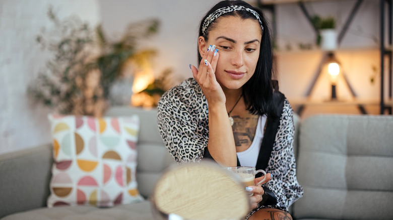 Woman applying facial mositurizer