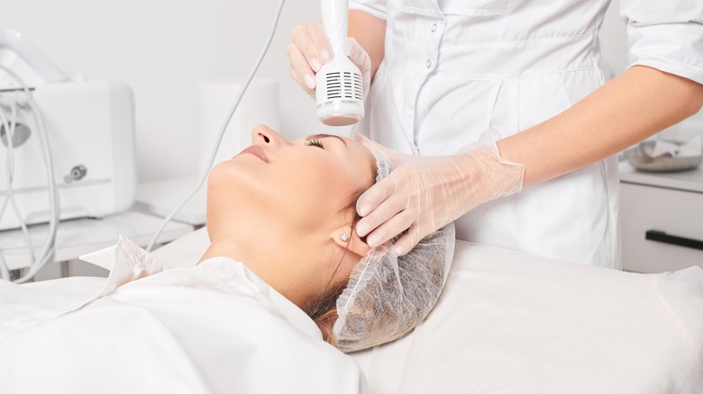 woman getting facial cryotherapy