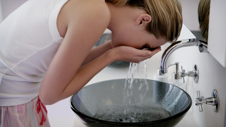 Woman washing face 