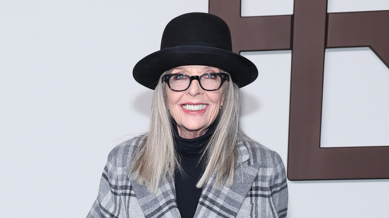 Diane Keaton posing in black-rimmed glasses
