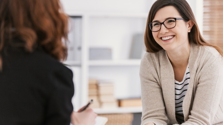 Woman smiling at another woman