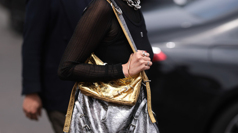 woman holding gold metallic bag