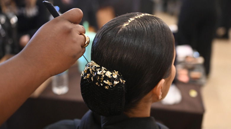 Model wearing gold-leafed hair