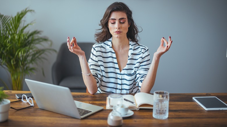 person meditating at desk