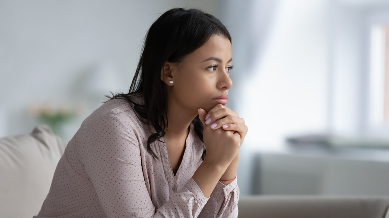 Stressed woman sitting on sofa